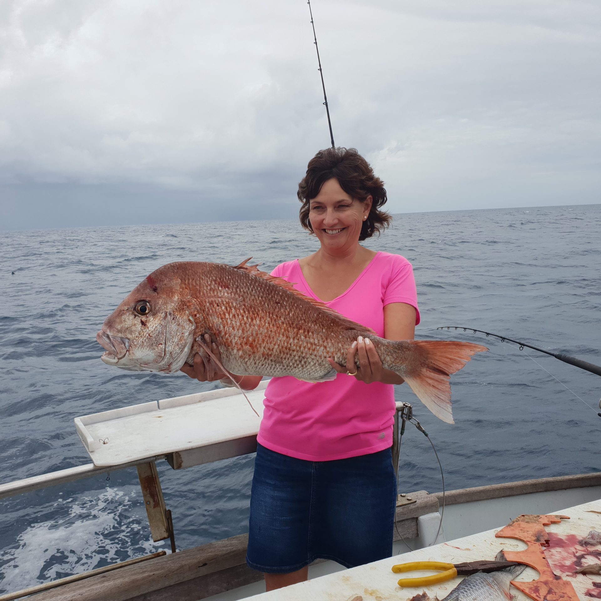 a person holding a dog in a body of water
