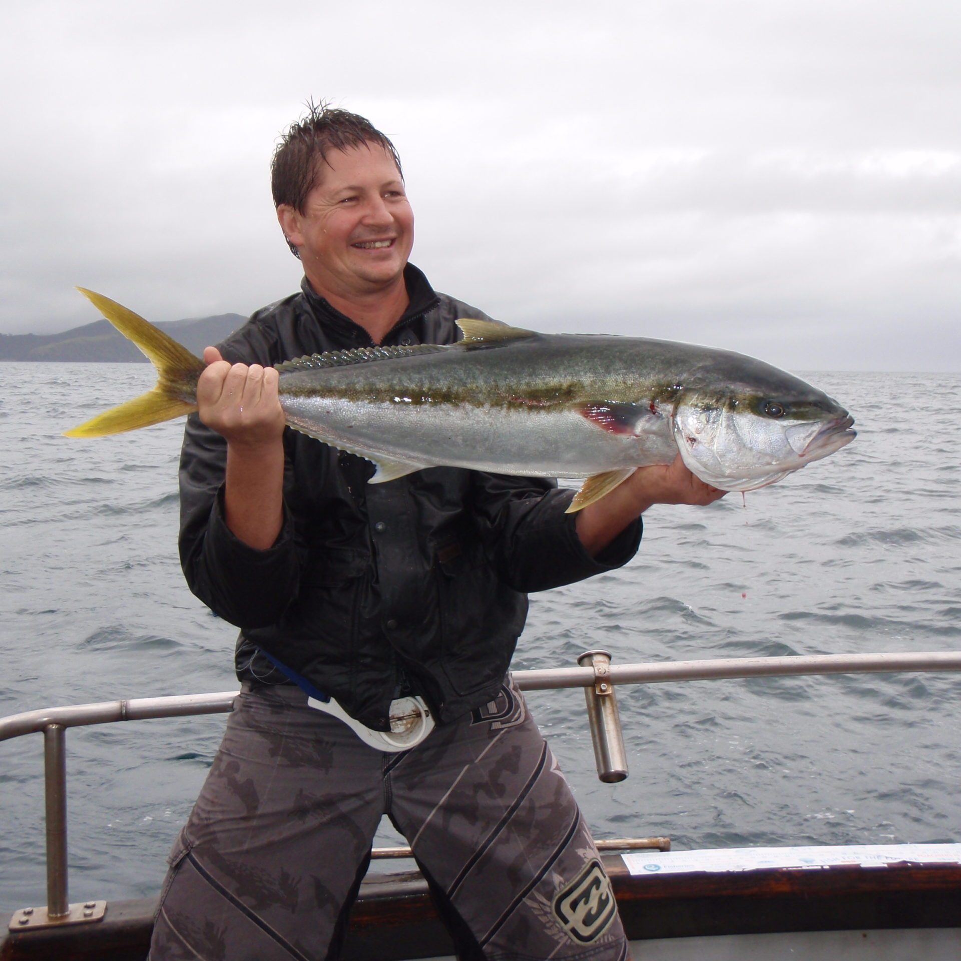 a man holding a fish in the water